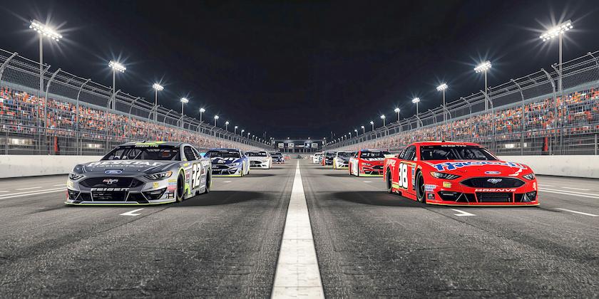 A nighttime view of the Bass Pro Shops Night Race, showing several NASCAR cars lined up.