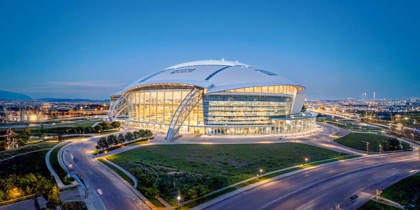 A panoramic view of AT&T Stadium at night.