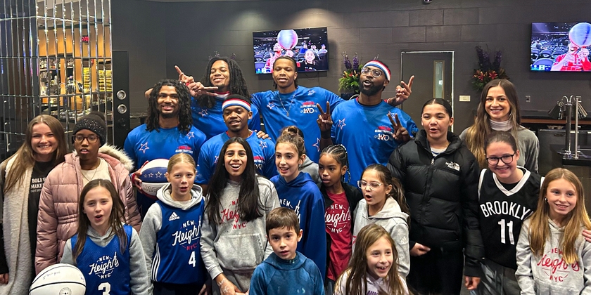 The Harlem Globetrotters sharing with the New Heights Girls.
