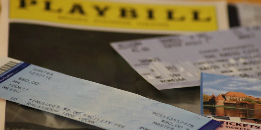 A pile of Broadway tickets, theatre stubs, and show playbills.