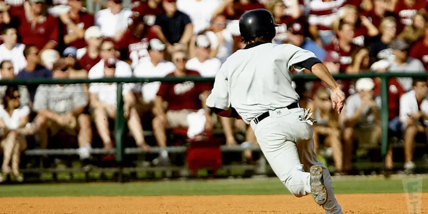 A baseball player runs the bases.