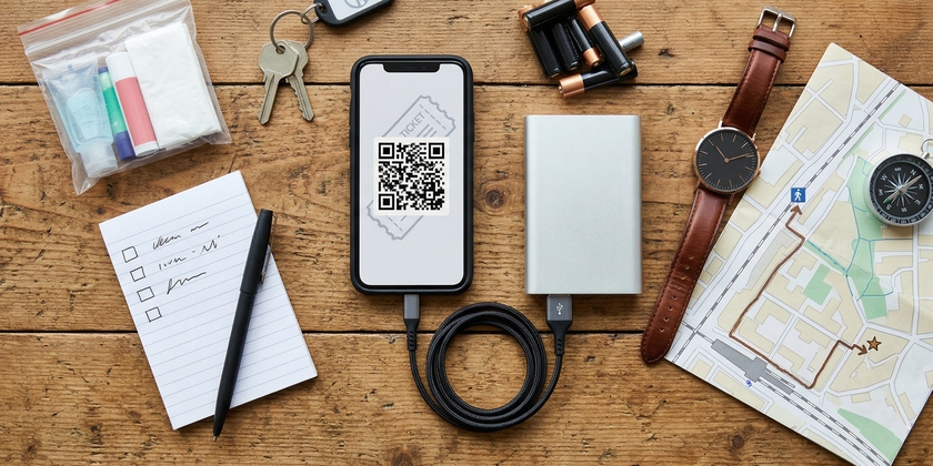 A phone with a ticket barcode, a checklist, lip balm, keys, and a watch.