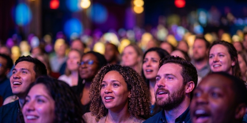 An audience watching a Broadway show.