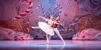 A pair of dancers performing The Nutcracker on stage.