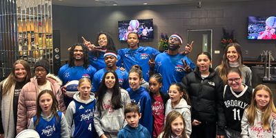 The Harlem Globetrotters sharing with the New Heights Girls.