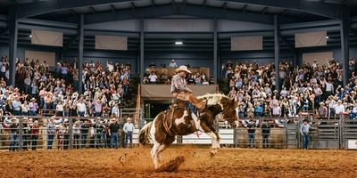 A cowboy riding a bucking horse at the Cowtown Coliseum in Fort Worth.