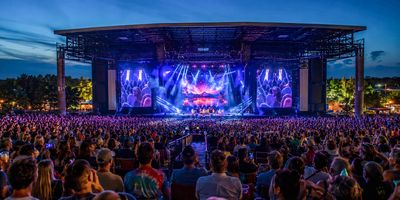 Live concert at Ruoff Music Center showing a massive crowd. 