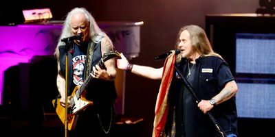 Lynyrd Skynyrd performs on stage.